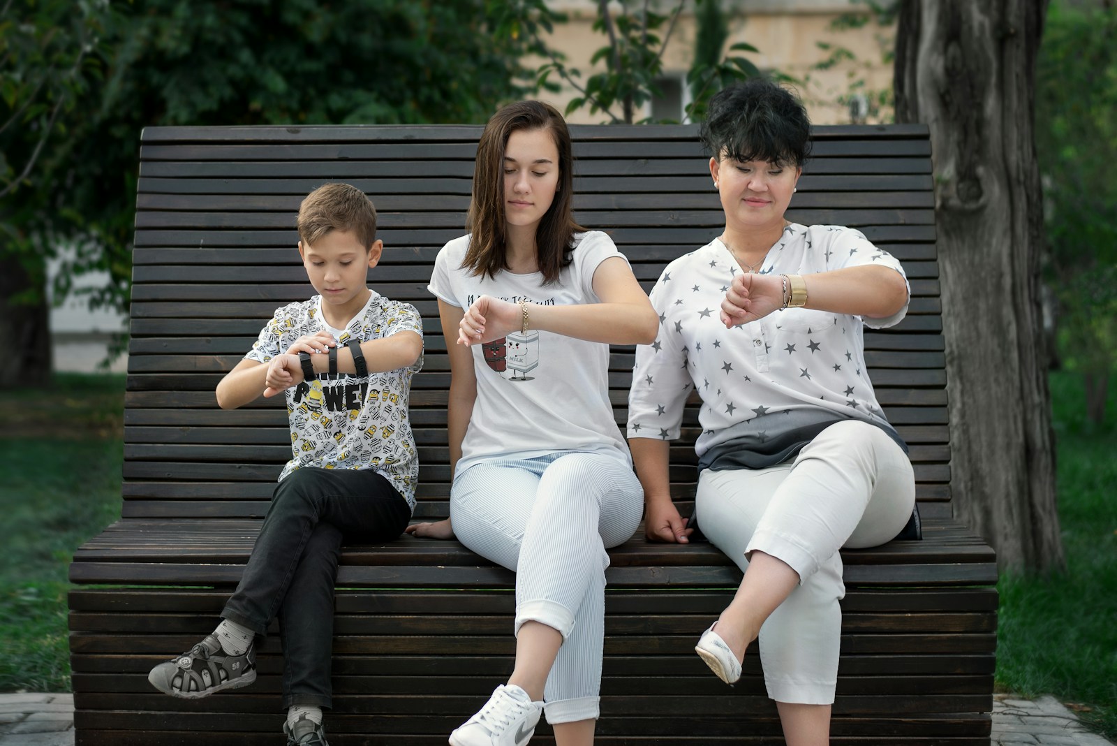 man and woman sitting on brown wooden bench